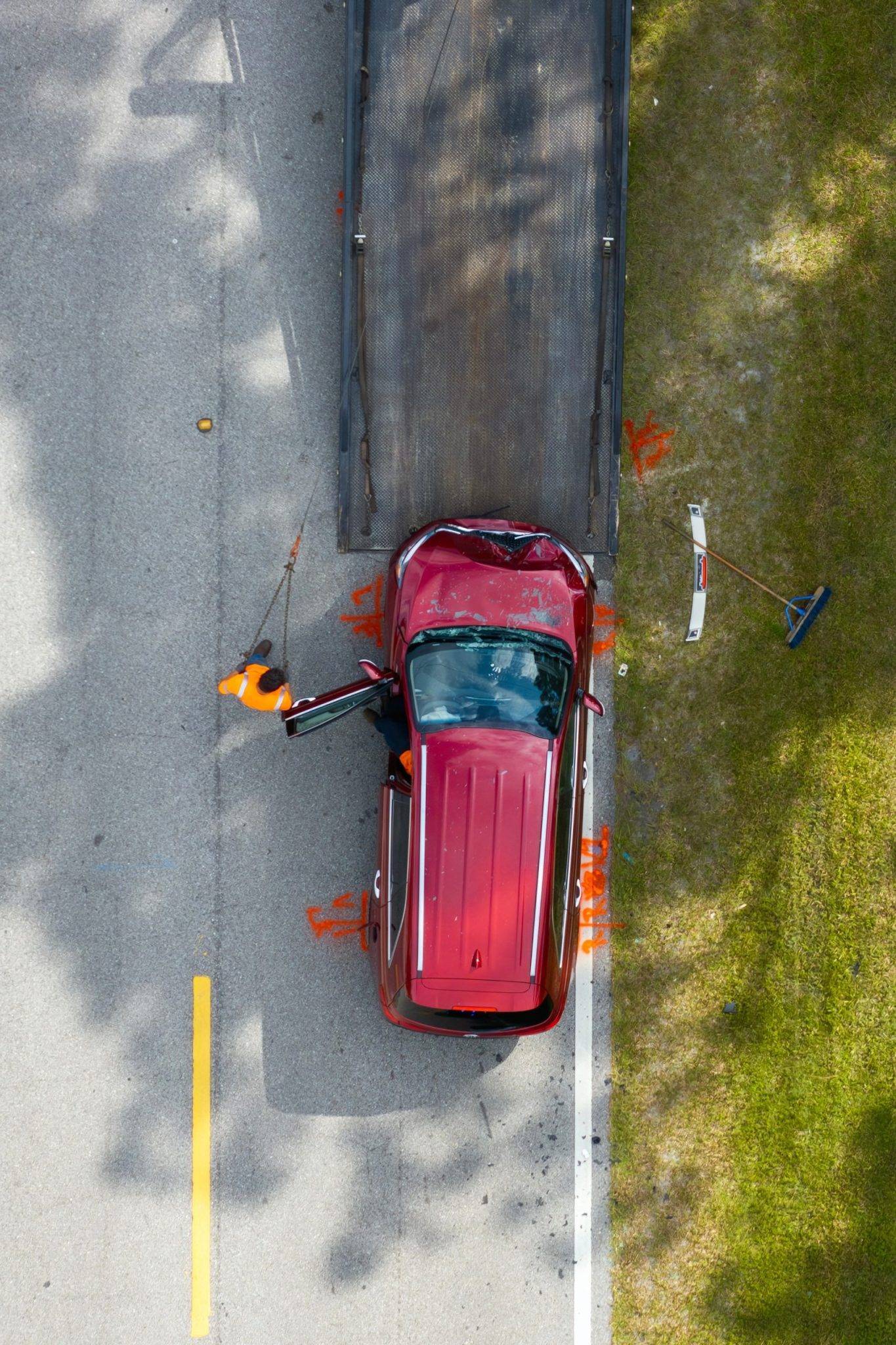 Car Crash Site With Tow Truck Loading Destroyed Vehicle On American Street. Emergency Services Personnel Responding To Accident In Florida, Usa